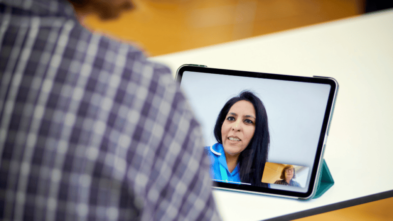 A woman on a video call with an Admiral Nurse, seeking advice from her living room.