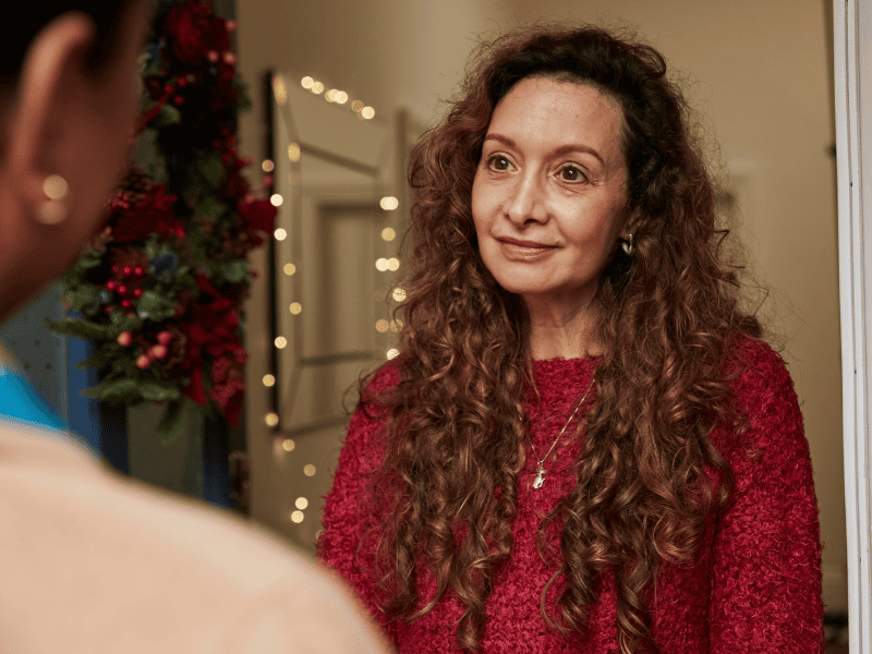 Woman welcoming family into home