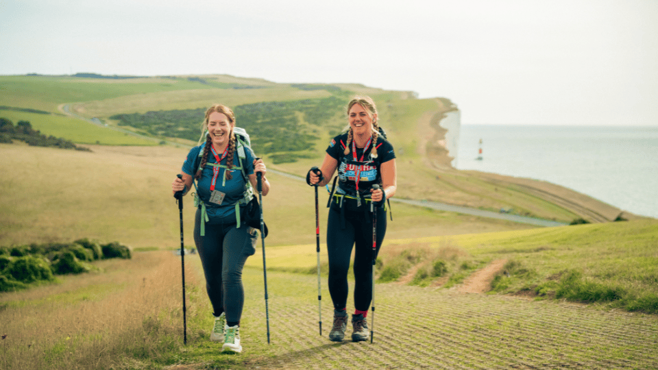 Two women walking along the south coast path