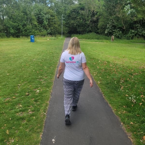 Anna Lisa walks down path wearing Dementia UK t-shirt