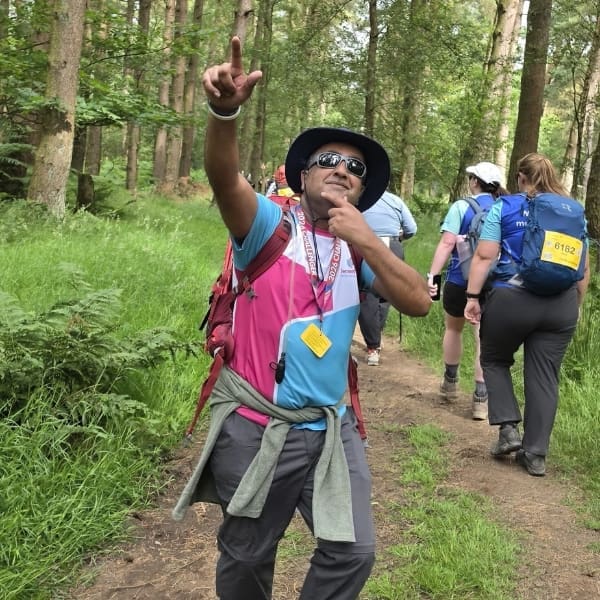 Dementia UK supporter Davinder posing while hiking the Peak district