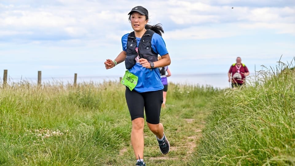 a woman running in the countryside
