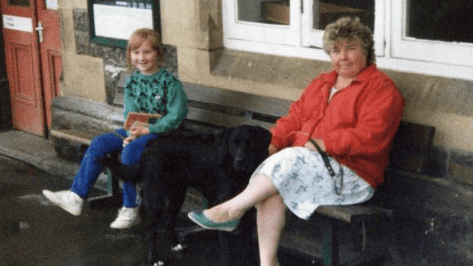 Admiral Nurse Cheryl is pictured as a young girl waiting at the train station, sitting next to her grandmother Joan.