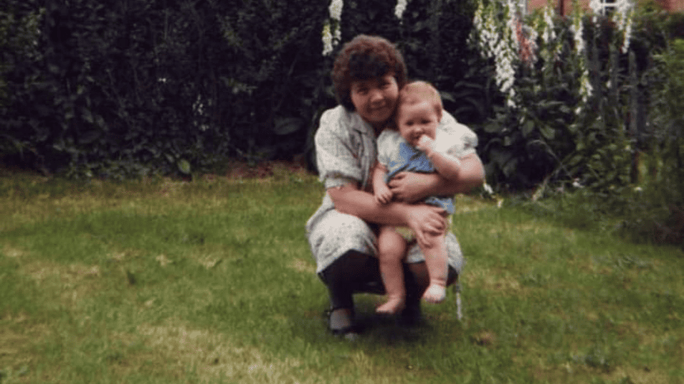 Admiral Nurse Cheryl is pictured as a baby, being held by her grandmother Joan, in the garden
