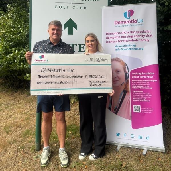 Supporter Ian Holt presenting a cheque to Dementia UK