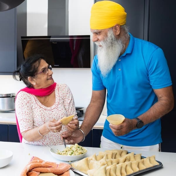 Ravinder (left) and Manny (right) making samosas together