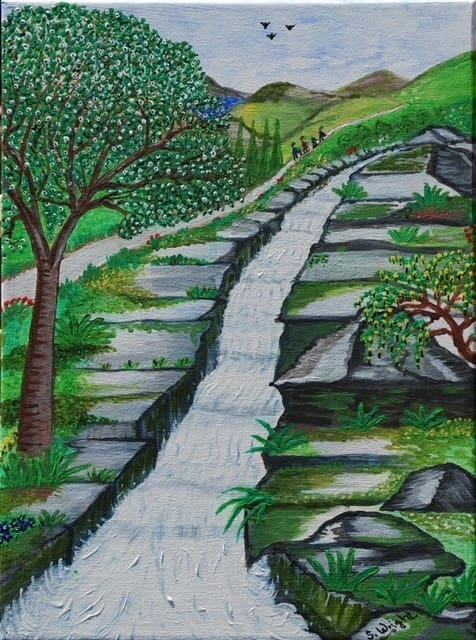 Four people walk down a path alongside a stream