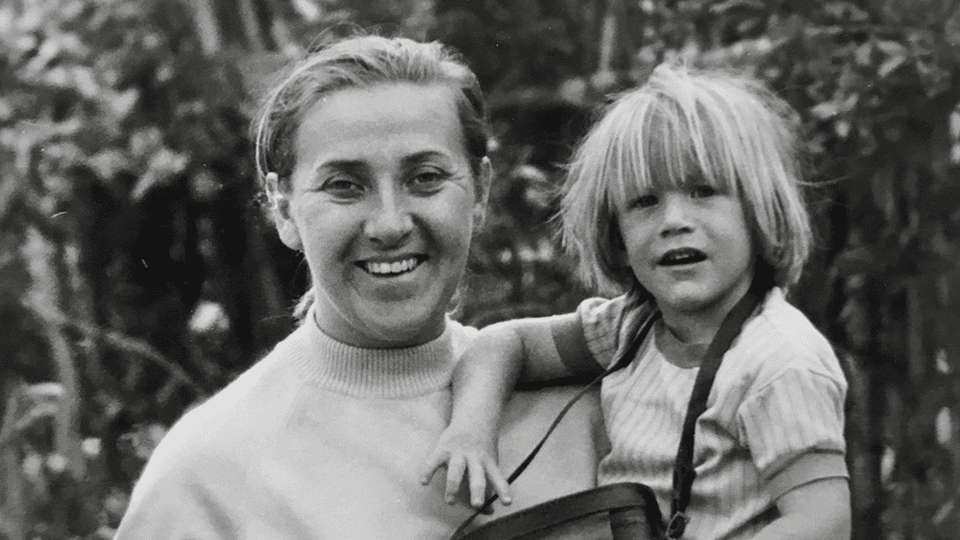 Steve as a young child is held by his mum