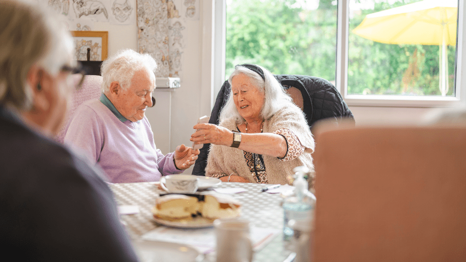 Man and women chatting and drinking a hot drink