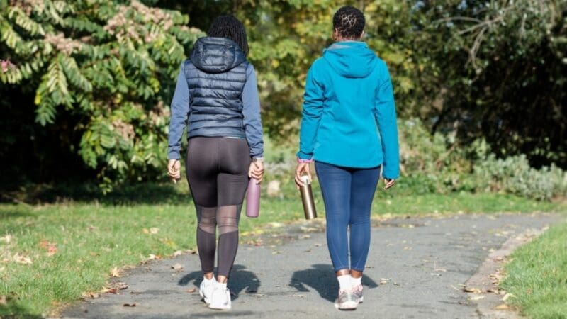 two people walking on a path