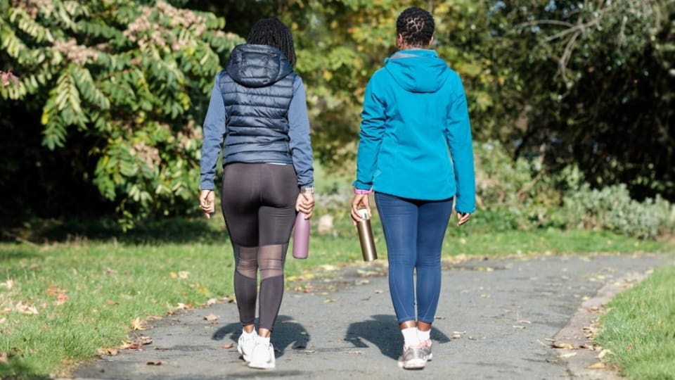 two people walking on a path