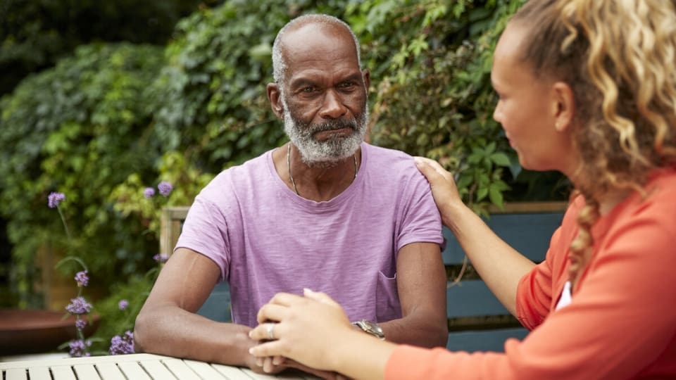 woman comforting her elderly father
